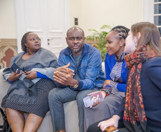 Students sitting on a couch talking
